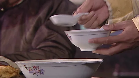 While dining, use the utensils to serve the soup Stock Footage 276516447