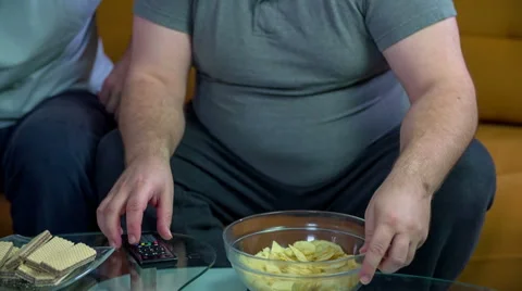 While eating snacks watching the game Stock Footage 46886611