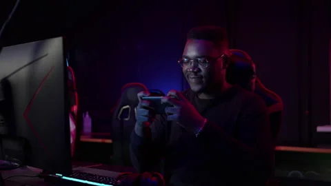 While the entire cyber team has gone to rest, the african guy is playing in the Stock Footage 152798924