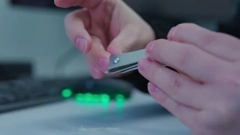 While having break a person cutting nails on a workplace Stock Footage 273307485