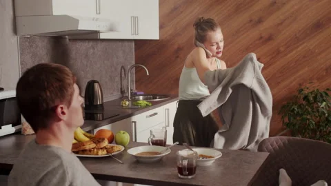 While the husband calmly drinks tea in the morning, the wife is late for work Stock Footage 145071652