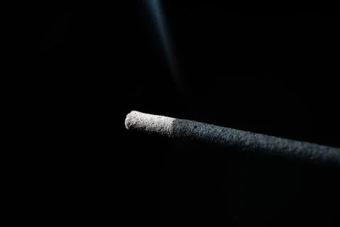 While the incense tip is on fire and smoking the smoke close up Stock Photos