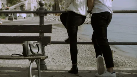 While an Italian couple look out at the coast, a kid runs and steals her bag and Stock Footage 199460296