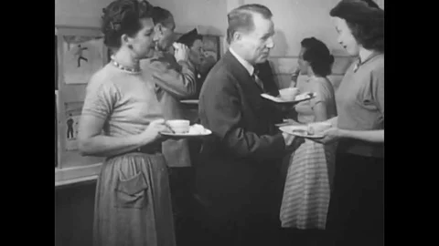 While members of the PTA are eating refreshments after a meeting, a teacher Stock-Footage 147391469