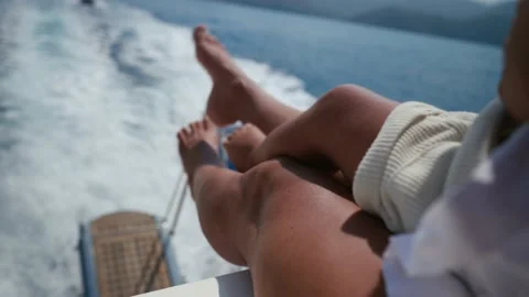 While resting on a yacht, the mother sit with her baby at dusk, family Video stock 205009747