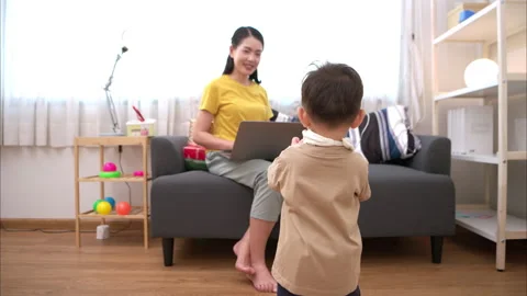 While in vacation at home, a mother engages in activities with little kid Stock Footage 310098573
