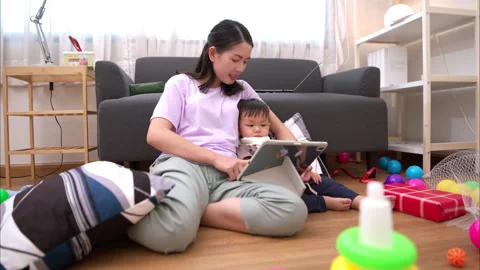 While in vacation at home, a mother engages in activities Stock Footage 310103563