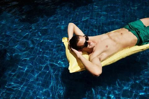 Whiling away the hours in the pool Stock Photos