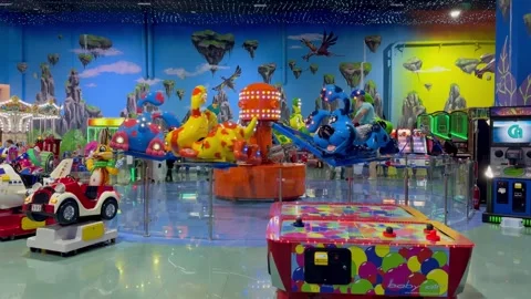 Whimsical carousel spins, adorned with vibrant animals, enchanting children with Stock Footage 264803606