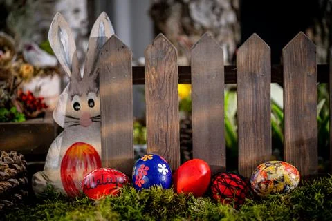 Whimsical Easter Scene: Handcrafted Eggs, Cute Bunny Cutout, and Rustic Fence 写真素材