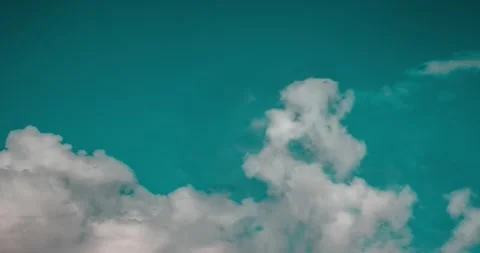 Whimsical transformations of white clouds against a blue sky. 库存影片 146534976