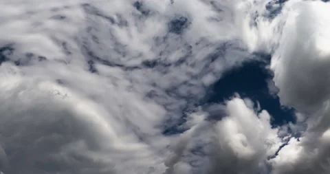 Whimsical transformations of white clouds against a blue sky. Stock Footage 146535262