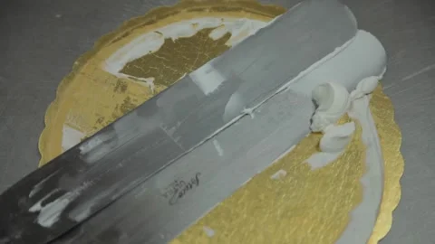 Whip pan to spatulas in a baker's kitchen Stock Footage 231414512