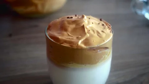 Whipped coffee latte garnishing with instant coffee. Mocha coffee garnishing . Stock Footage