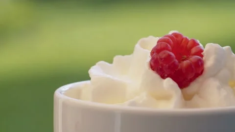 Whipped cream and raspberry in a cup Stock Footage 137646813