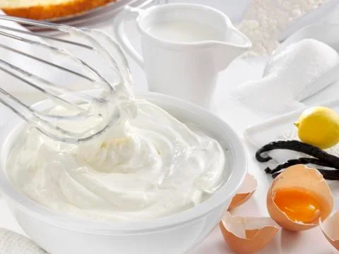Whipped cream and various baking ingredients Stock Photos