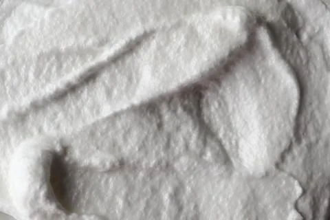 Whipped cream texture on a surface in a kitchen setting during the day Stock Photos