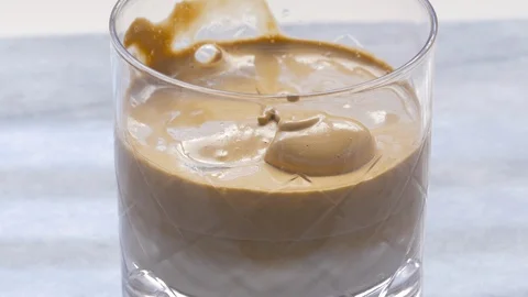 Whipped Dalgona Coffee in a Glass Stock Footage 128457784