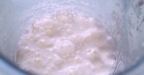 A whipped milkshake in a plastic cup.A close-up Stock Footage 333576739
