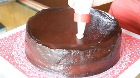 WhippedCreamDecoratingOnChocolateCake HD Stock Footage 25481237