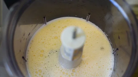 Whipping chicken eggs in a food processor for dough preparation Stock Footage 91081018