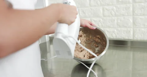 Whipping the cream for ganache. Baking process stages. Hands of female Stock Footage 150267412