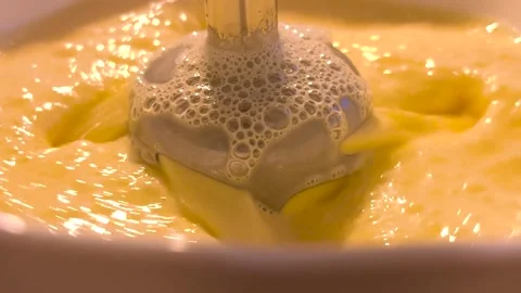 Whipping the cream with a mixer. Automatic flour mixing machine mixing cream Stock Footage 277199440