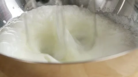 Whipping cream until stiff using an electric whisk Stock Footage 24665207