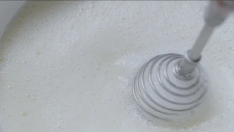 Whipping cream using hand whisk, close-up. Stock Footage 257364749