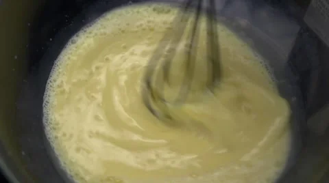 Whipping eggs with a whisk Stock Footage 64702420