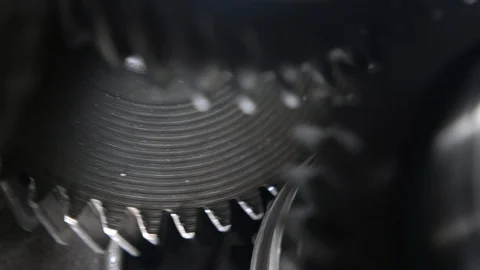 Whirling scallops of two broad cogs working askew in a contemporary transmission Video stock 124459510