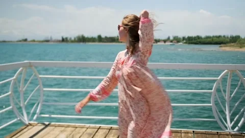 Whirling in a sensual dance, a young seductive woman on picturesque sea Video stock 278212251