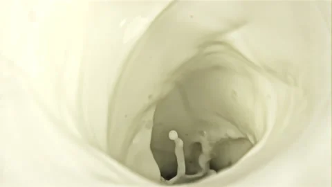A whirlpool of fresh milk with air bubbles. Filmed on a high-speed camera at Stock Footage 169476509