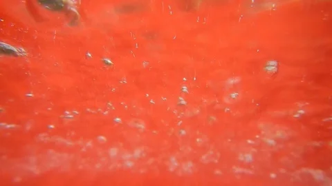 Whirlwind of bubbles and bubbling in a red liquid Stock Footage 109289428