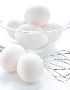 Whisk and fresh eggs Stock Photos