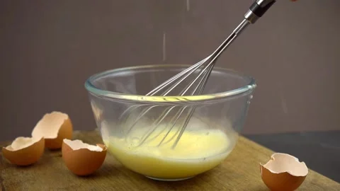 Whisk eggs with salt to make omelette	 Stock Footage 134022358