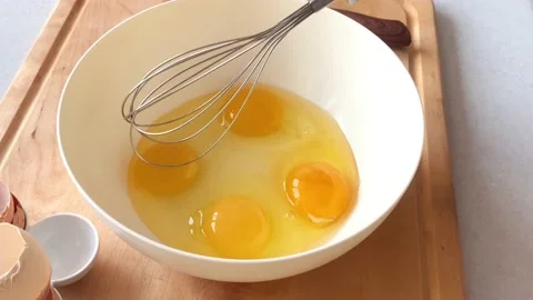 Whisk eggs in a white plate Stock Footage 225046363