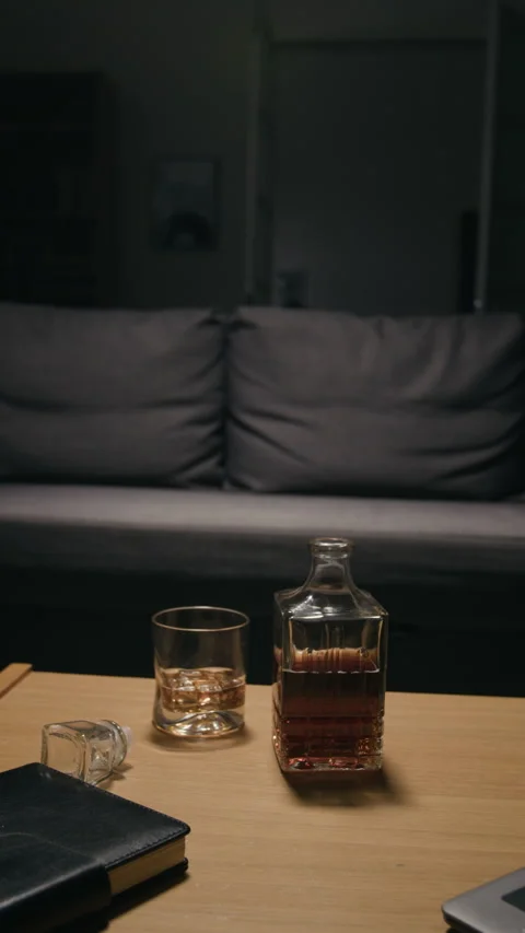 Whiskey Bottle with Glass Representing Alcohol Addiction Concept Stock Footage 344871576