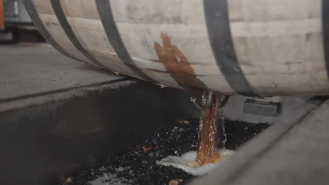 Whiskey Bourbon Barrels Being Dumped and Poured  Stock Footage 240028192