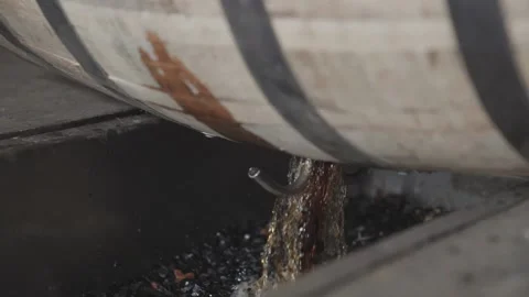Whiskey Bourbon Barrels Being Dumped and Poured  Stock Footage 240028194