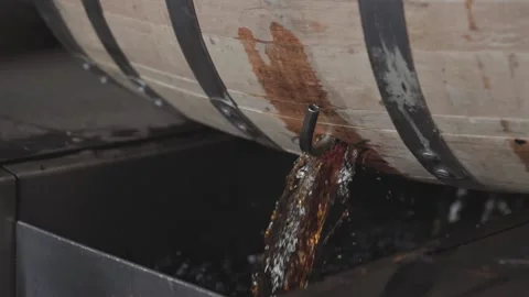 Whiskey Bourbon Barrels Being Dumped and Poured  Stock Footage 240028218