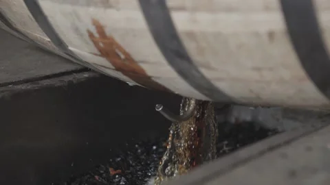 Whiskey Bourbon Barrels Being Dumped and Poured  Stock Footage 240028226