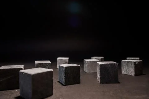 Whiskey cubes lie on a dark background. Stones for cooling drinks. Stock Photos