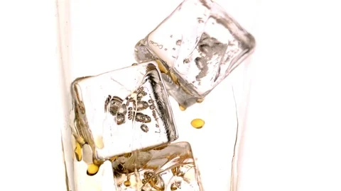 Whiskey drops dripping from the ice cubes in slow motion Stock Footage 81223891