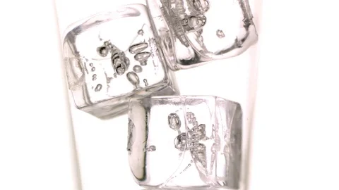 Whiskey flowing through the ice cubes into the glass in slow motion Stock Footage 81226541