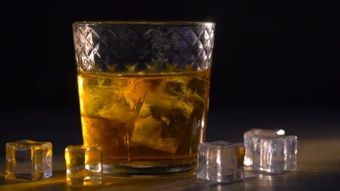 Whiskey in glass with cubes of ice Stock Footage 107921749