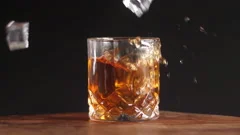 Premium Photo  Glass with whiskey and falling ice cube with splashes