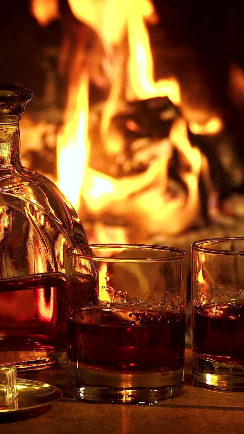 Whiskey Glasses by the Fireplace Stock Footage 314155866