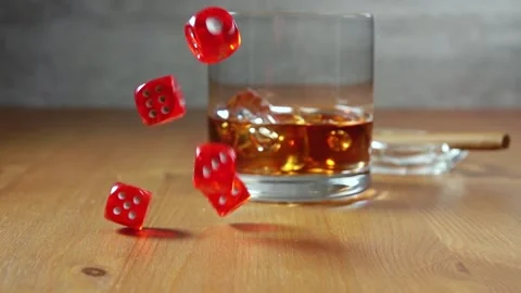 Whiskey in Highball on a Wooden Table and Dice. Slow Motion Stock Footage 129352715