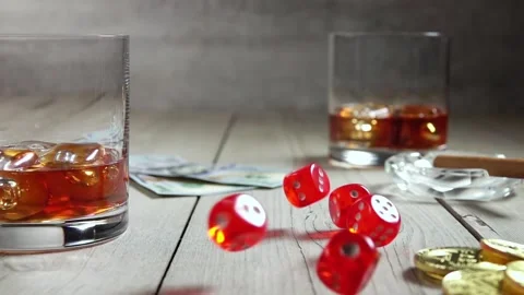 Whiskey in Highballs on a Wooden Table and Dice. Slow Motion Stock Footage 129665291